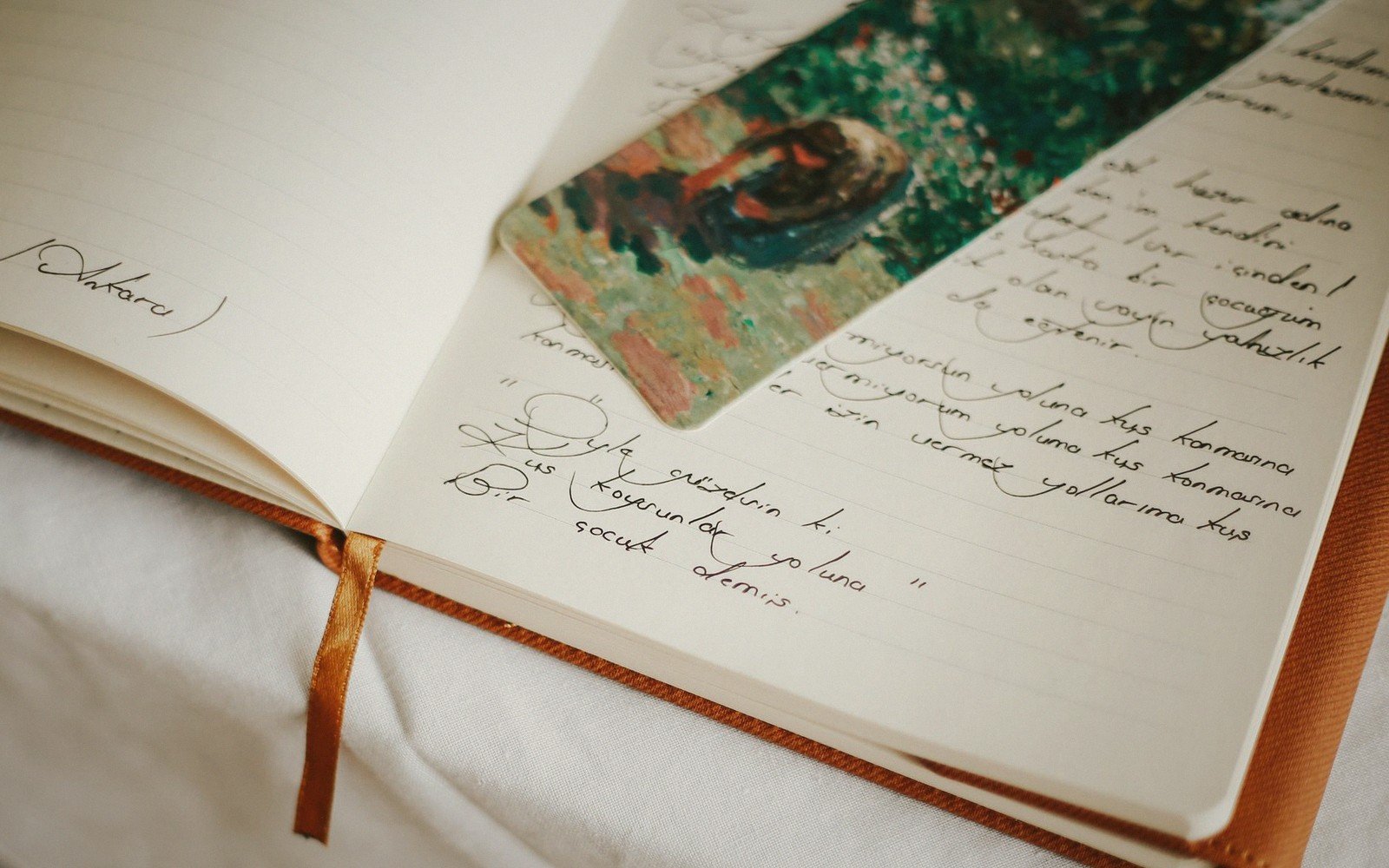 Open notebook and pen beside a closed book